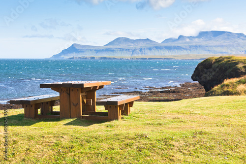 Wooden table and benches in resting area photo