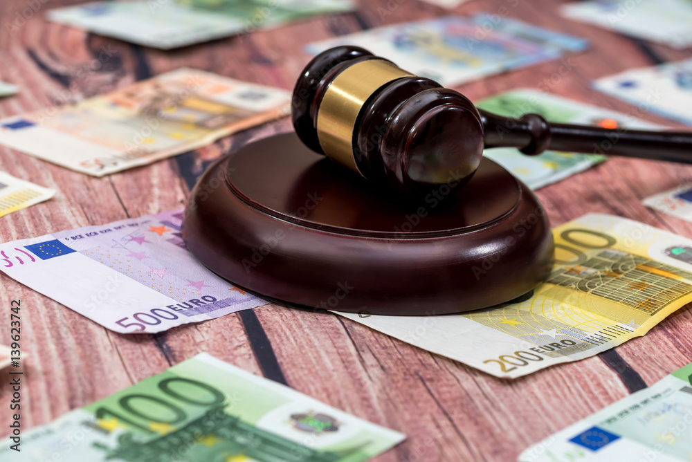 gavel and euros money on wooden table. close up.
