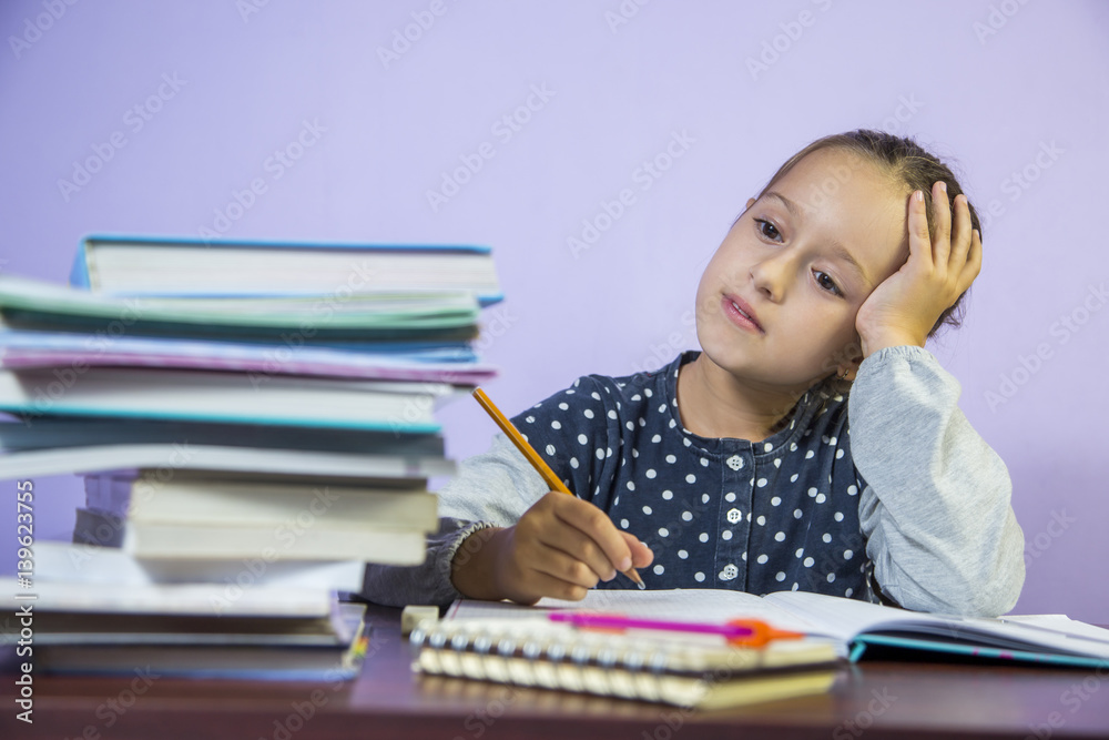 Little schoolgirl studying at home. Little schoolgirl studying at home.