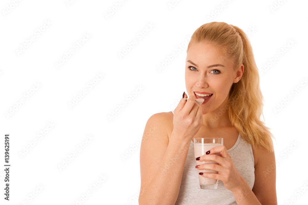 Cute blonde woman eating fruit yogurt isolated over white background Cute blonde woman eating fruit yogurt isolated over white background