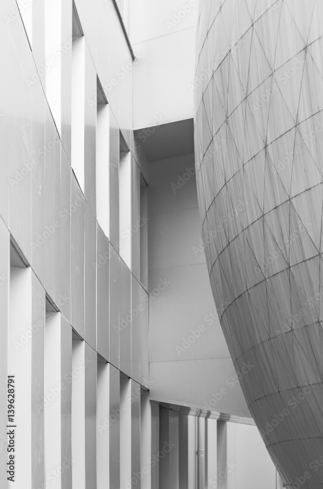 Fototapeta premium Monochrome black and white photo of elements modern building. Dome trimmed with triangular aluminum panels. Abstract bark background