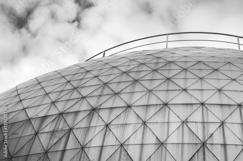 Monochrome black and white photo of elements modern building. Dome trimmed with triangular aluminum panels. Abstract bark background