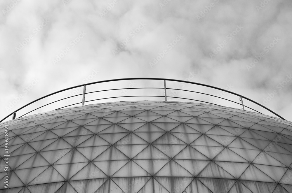Fototapeta premium Monochrome black and white photo of elements modern building. Dome trimmed with triangular aluminum panels. Abstract bark background
