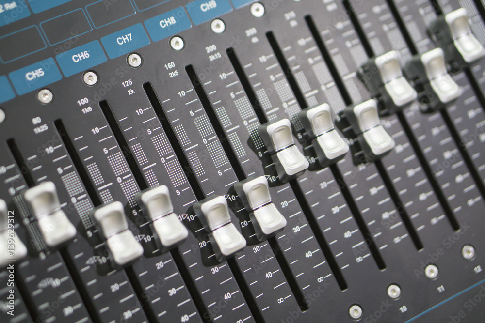 studio working with sound and light mixer console for the sound engineer working on recording studio mixer adjusting the volume of a sound mixer audio mixing console with mixer board,selective focus