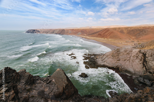 Rough colorful coastline, Atlantic, Morocco photo