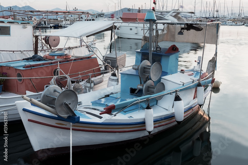 greek traditional small blue boat in the port © mtv2021