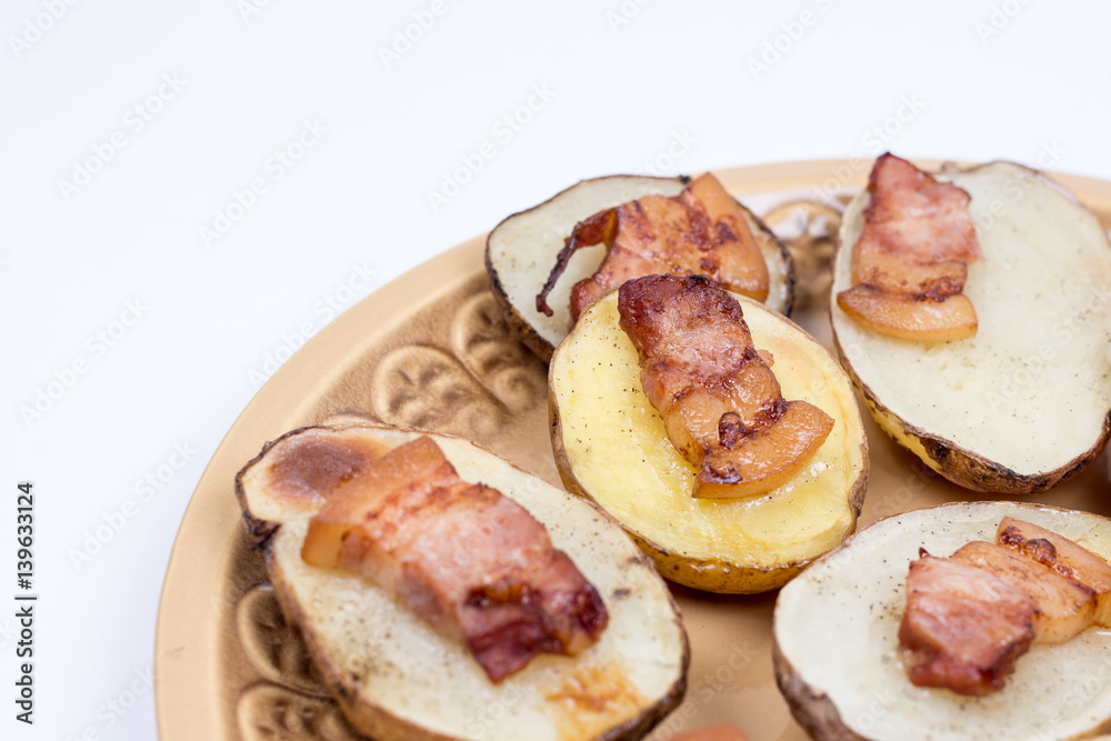 Fried bacon on baked potatoes with copy space