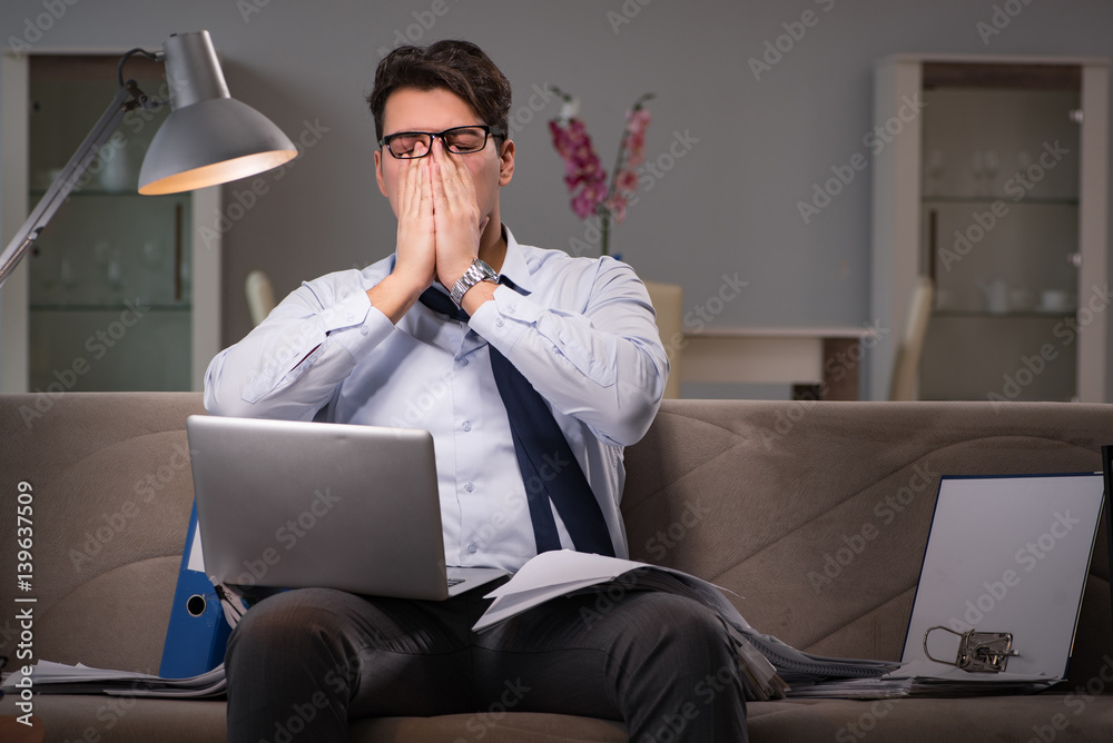 Businessman workaholic working late at home
