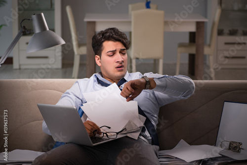 Принти на полотні Businessman workaholic working late at home