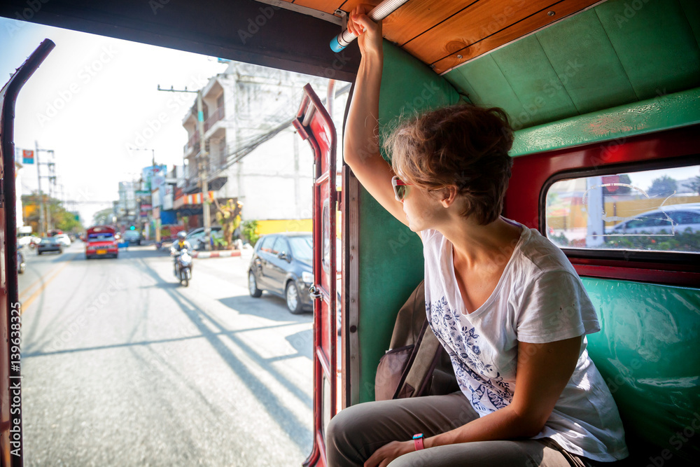 Obraz premium woman tourist traveling to the Thai public transport, Songteo