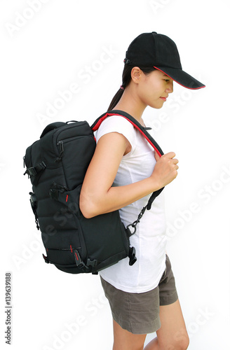 Portrait of young woman traveler with bag going on a journey on white background