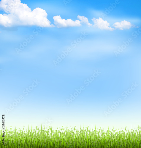 Green grass lawn with clouds on blue sky