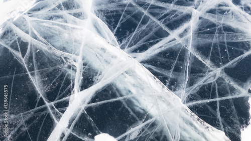 Texture of ice of Baikal lake in Siberia. Dark blue ice surface pattern. ice and cracks on the surface of Lake Baikal