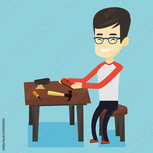 Shoemaker making handmade shoes in workshop.