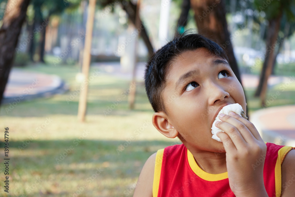 the boy eating steamed dumpling, breakfast before exercise the boy eating steamed dumpling, breakfast before exercise