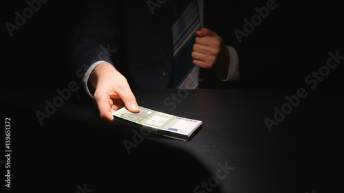 BRIBE: Businessman takes out a money from a pocket of a suit (EURO) - Two person