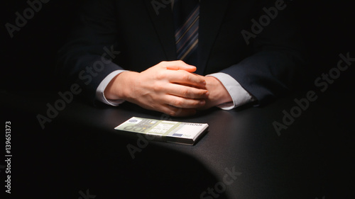 BRIBE: Businessman waits and puts a money on a table (EURO) - Two person