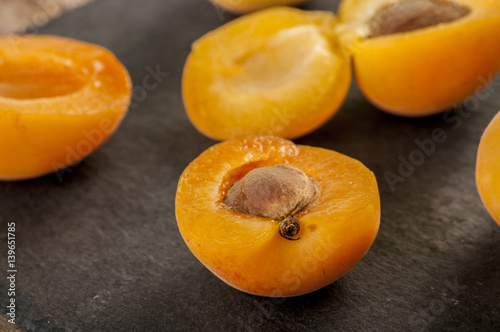 sliced apricots isolated on black background
