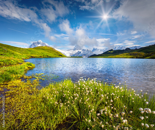 Wetterhorn and Wellhorn peaks in the morning mist on Bachsee lake