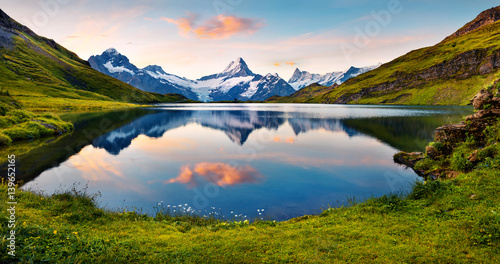Wetterhorn and Wellhorn peaks reflected in water surface of Bachsee lake
