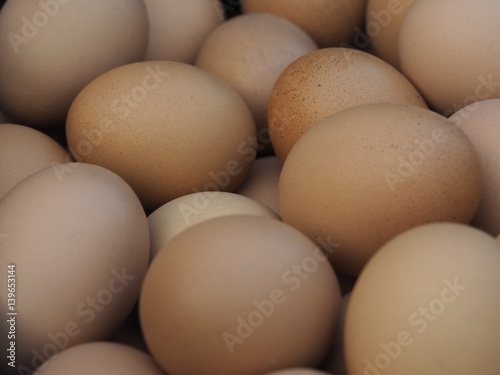 A Pile of Raw Fresh Brown Chicken Eggs Background