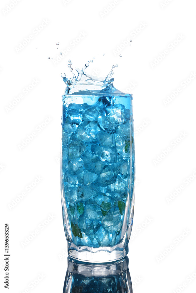 Glass of a blue alcoholic cocktail drink with ice and mint Glass of a blue alcoholic cocktail drink with ice and mint