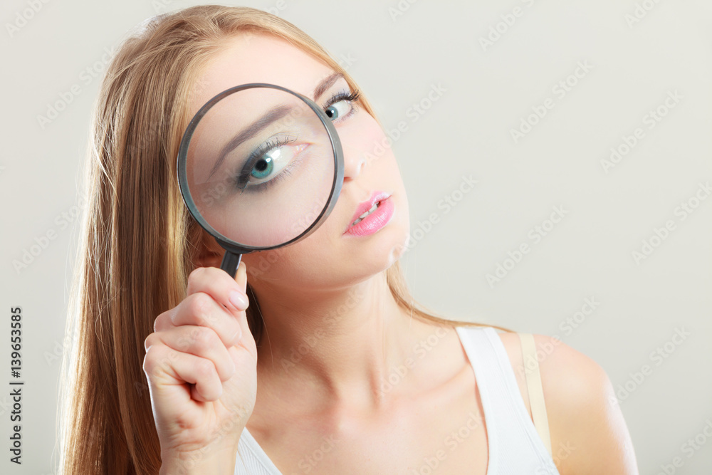 girl holding on eye magnifying glass loupe girl holding on eye magnifying glass loupe