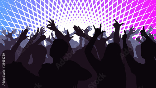 Silhouettes of dancing people in front of bright stage lights