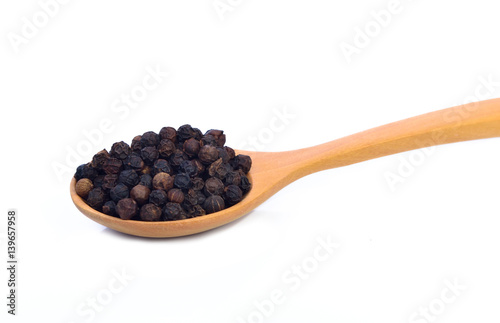 Black papper in spoon isolate on white background