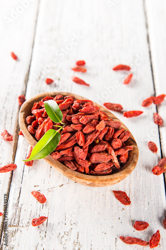 Dry goji berry on old white wooden background. photo