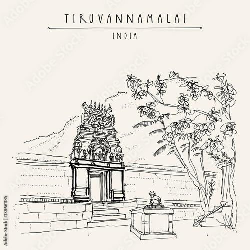 Tiruvannamalai, India. Arunachala mountain, small Hindu temple, cow statue photo