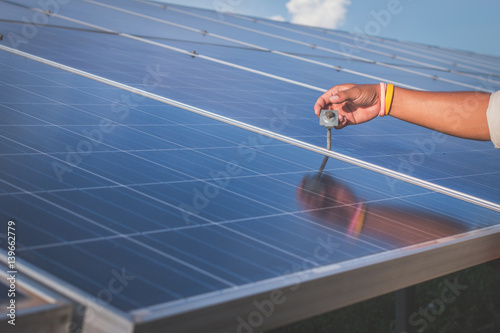 electrician working on installing solar panel in solar power plant