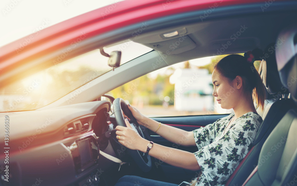 Fototapeta premium young woman happy in car