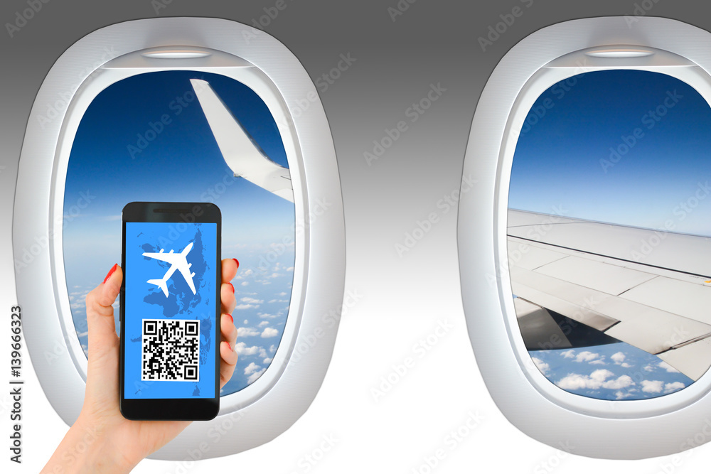 Mobile boarding pass or booking a flight with smartphone on airplane Mobile boarding pass or booking a flight with smartphone on airplane