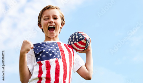 Portrait of happy little rugby player with ball