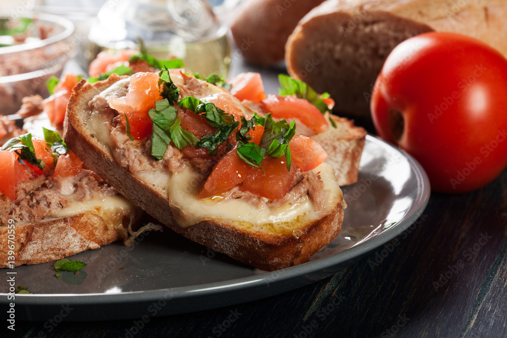 Appetizer bruschetta with tuna, mozarella cheese and tomatoes Appetizer bruschetta with tuna, mozarella cheese and tomatoes