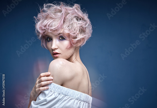 Closeup portrait of a cute girl with a pink hairstyle