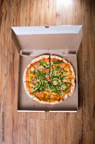 Italian pizza with green pepper in paper box tasty macro picture useful for background