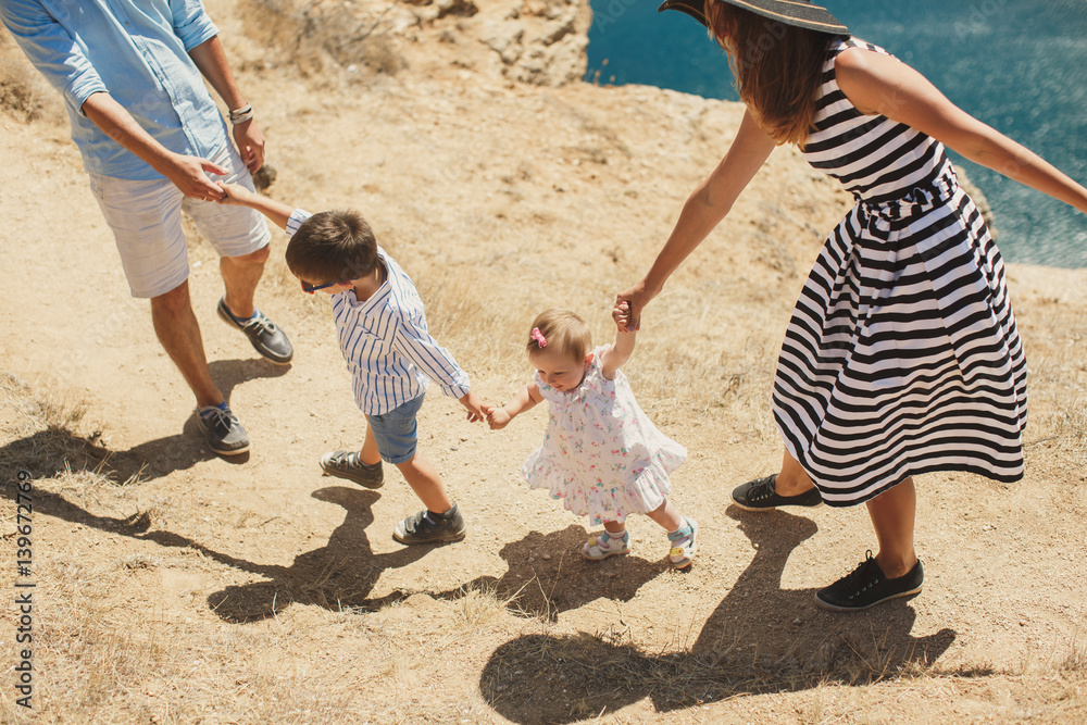 Happy family of four walking in the mountains. Family concept. Family trip. Happy family of four walking in the mountains. Family concept. Family trip.