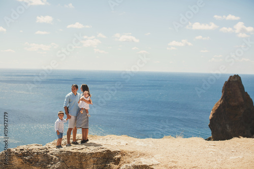 Happy family of four walking in the mountains. Family concept. Family trip.