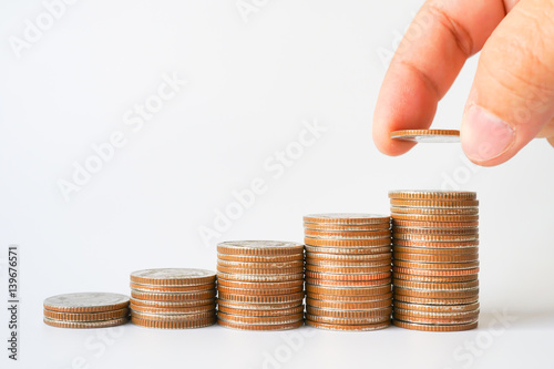 Money, Financial, Business Growth concept, stack of coins with Man's hand put money coins on white background with copyspace , Finance banking account and money currency saving background 