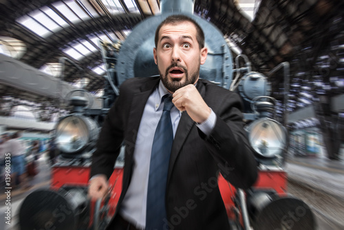 Фотография Businessman escaping from a vintage train