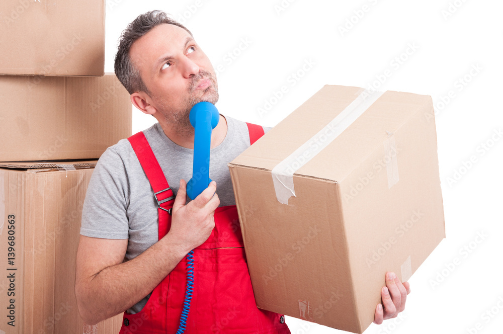 Mover man holding telephone receiver looking for idea Mover man holding telephone receiver looking for idea