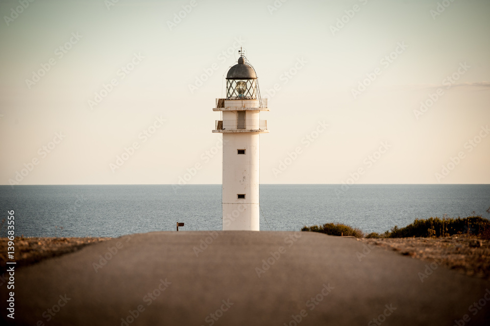 woman walking by a lighthouse