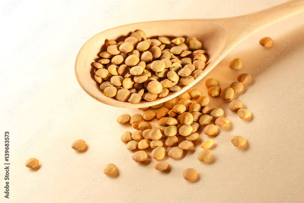 Raw lentil in wooden spoon Raw lentil in wooden spoon