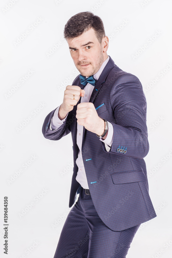Naklejka premium portrait of angry business man fists in air on white background.