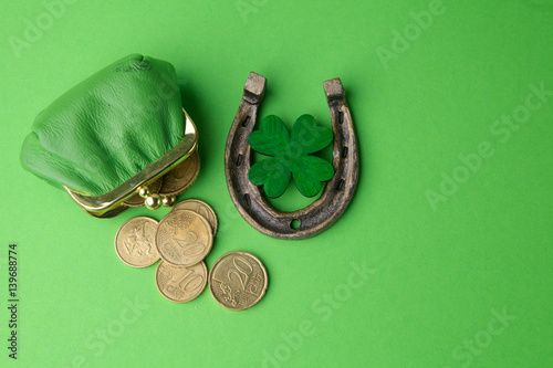 St. Patricks day, lucky charms. Horesechoe and shamrock on green background photo