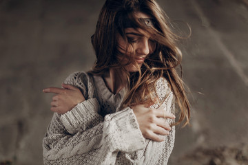 Beautiful hipster woman in boho indie clothes, posing in winter outdoor, face closeup, leather headband on brunnete hair
