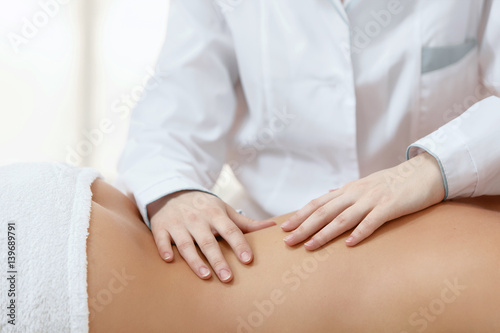 Beautiful Blond Woman Getting Spa Treatment. Masseur Brunette Girl Doing Massage