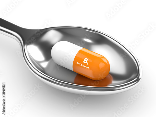 3d render of vitamin B3 pills on spoon photo